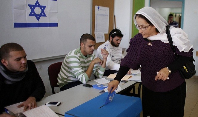 A Druze woman casts her ballot at a polling station in the northern Druze-Arab village of Maghar